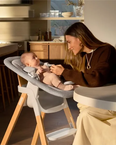 Nuna lifestyle / destination ad: A testament to our commitment to mindful design, the BRYN newborn rocker offers a simple transition from rocker to highchair.